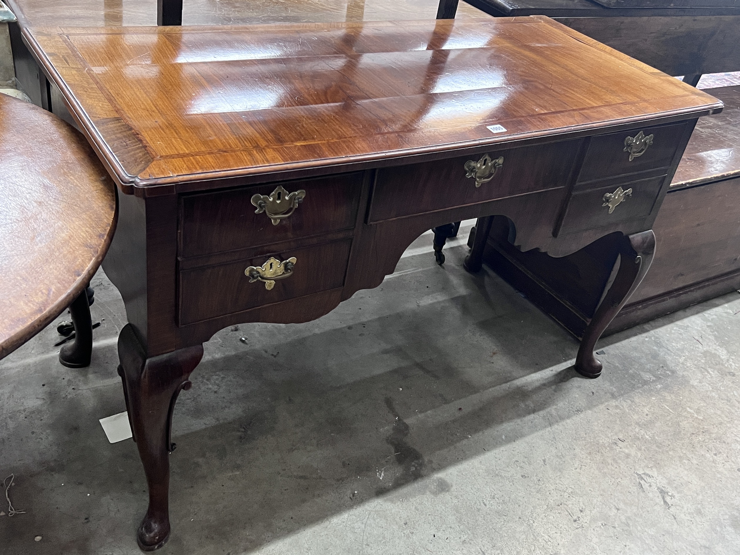 A Queen Anne revival feather banded walnut kneehole dressing table, width 129cm, depth 58cm, height 78cm